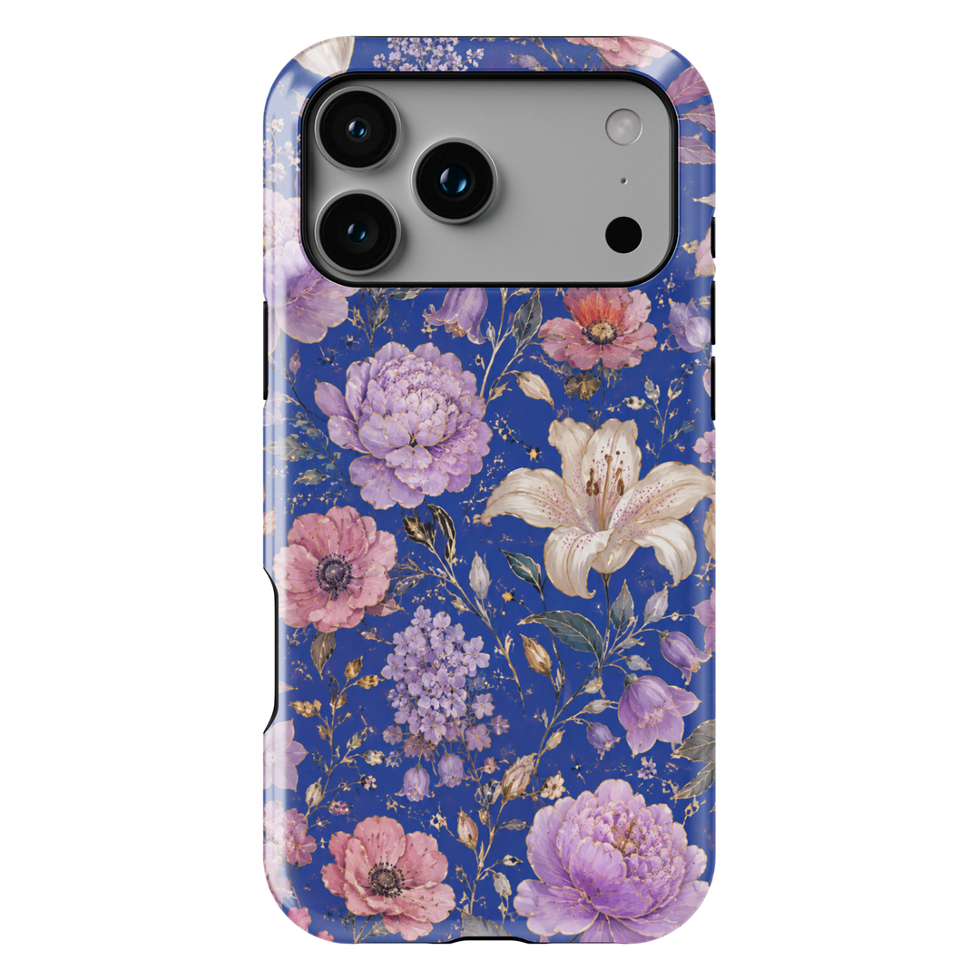 Electric Bloom iPhone case featuring vibrant coral, pink and orange flowers with green leaves on a cobalt blue background.
