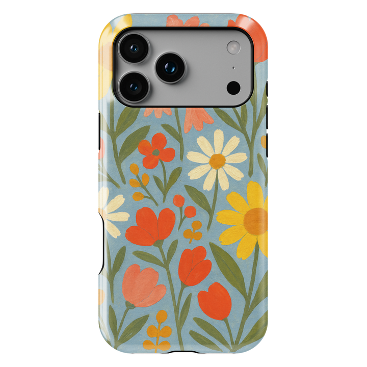 Retro floral iPhone case featuring colorful daisies, tulips, and wildflowers on a soft blue background with vintage folk art styling.