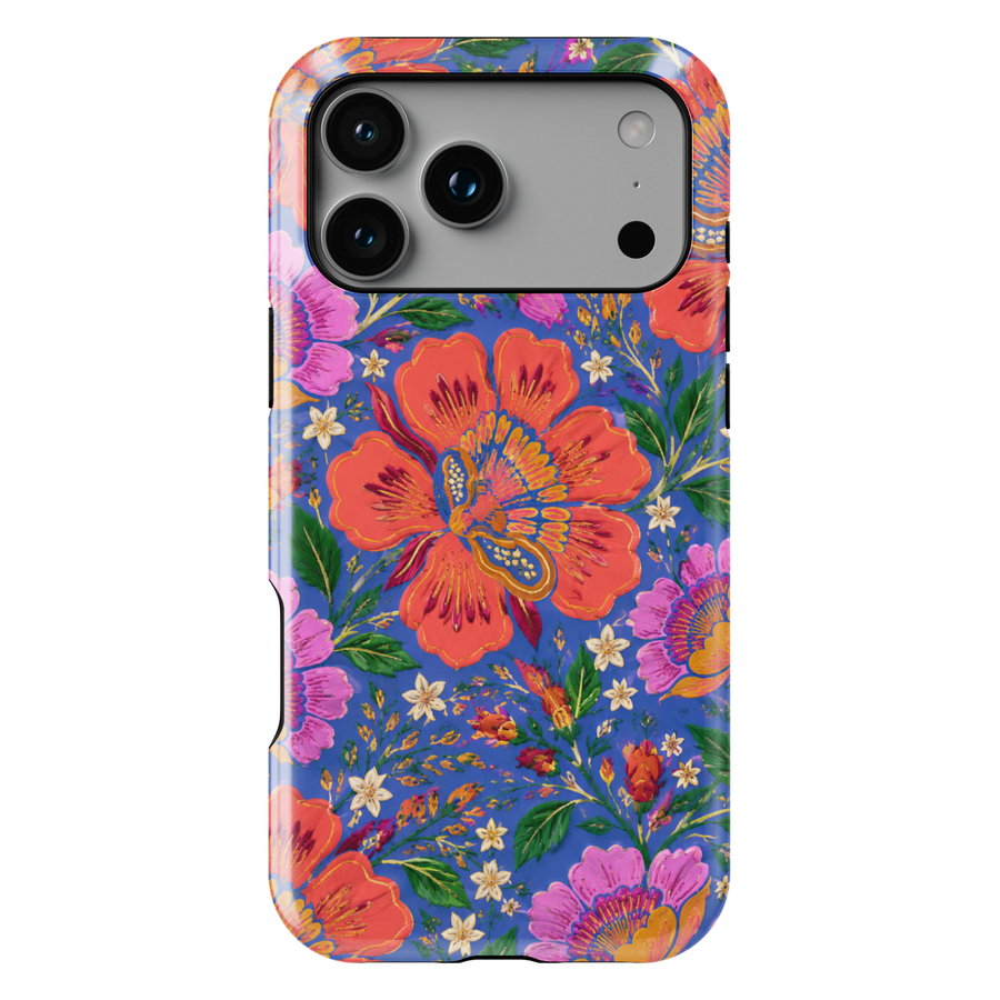 Electric Bloom iPhone case featuring vibrant coral, pink and orange flowers with green leaves on a cobalt blue background.