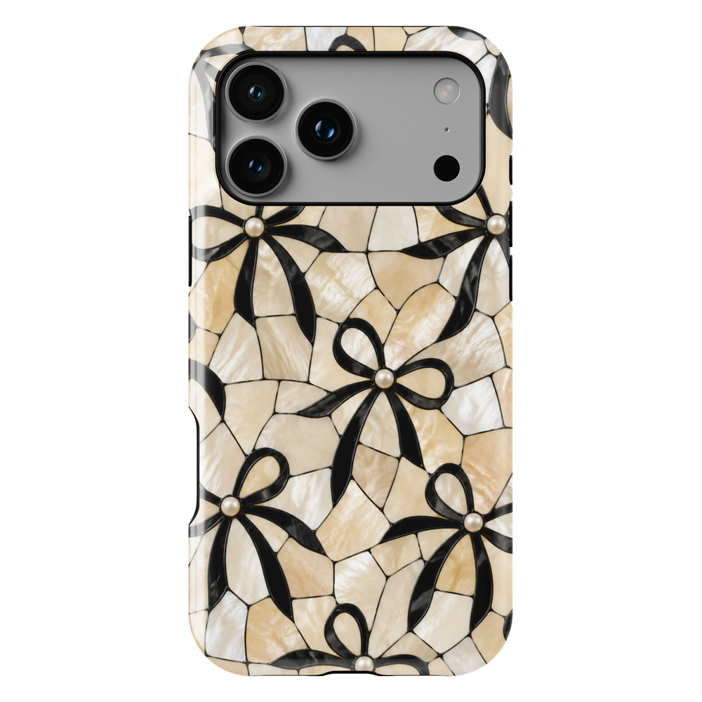 Ivory mosaic iPhone 17 Pro Max case with black bow pattern and pearl accents in a classy aesthetic design.