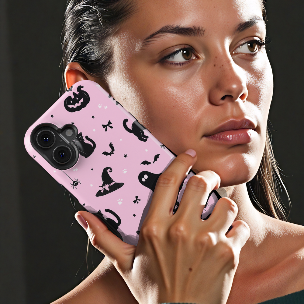 Pink Halloween iPhone case with black cats, ghosts, witch hats, bats, pumpkins, bows, spiders and paw prints.