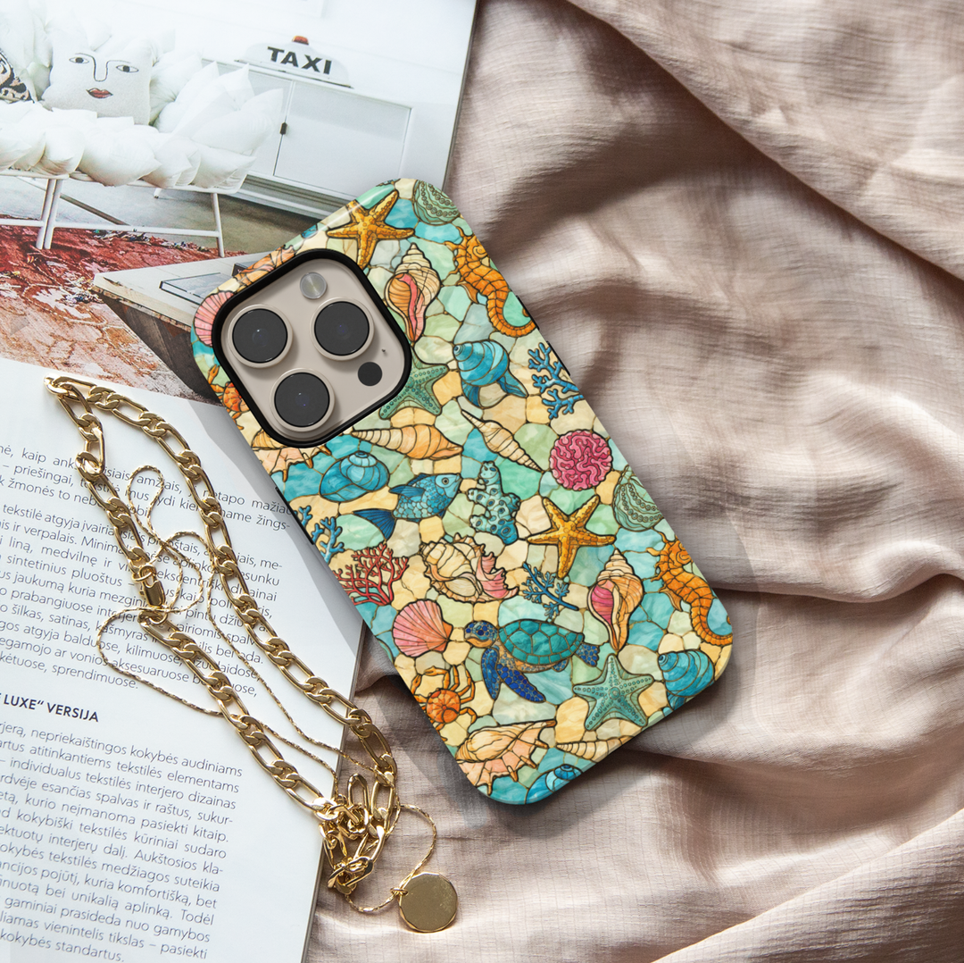 Sea life iPhone case featuring sea turtles, starfish, seashells, tropical fish, coral, and coastal stained glass artwork.