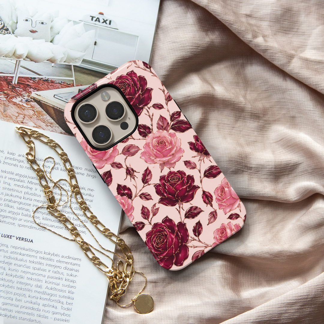 Secret Admirer burgundy rose iPhone 18 Pro Max MagSafe case featuring large blush pink and deep wine-red roses, burgundy leaves and delicate gold-toned floral outlines on a pale blush background, an elegant romantic tough iPhone 18 Pro floral phone case with feminine luxury aesthetic and MagSafe compatibility.