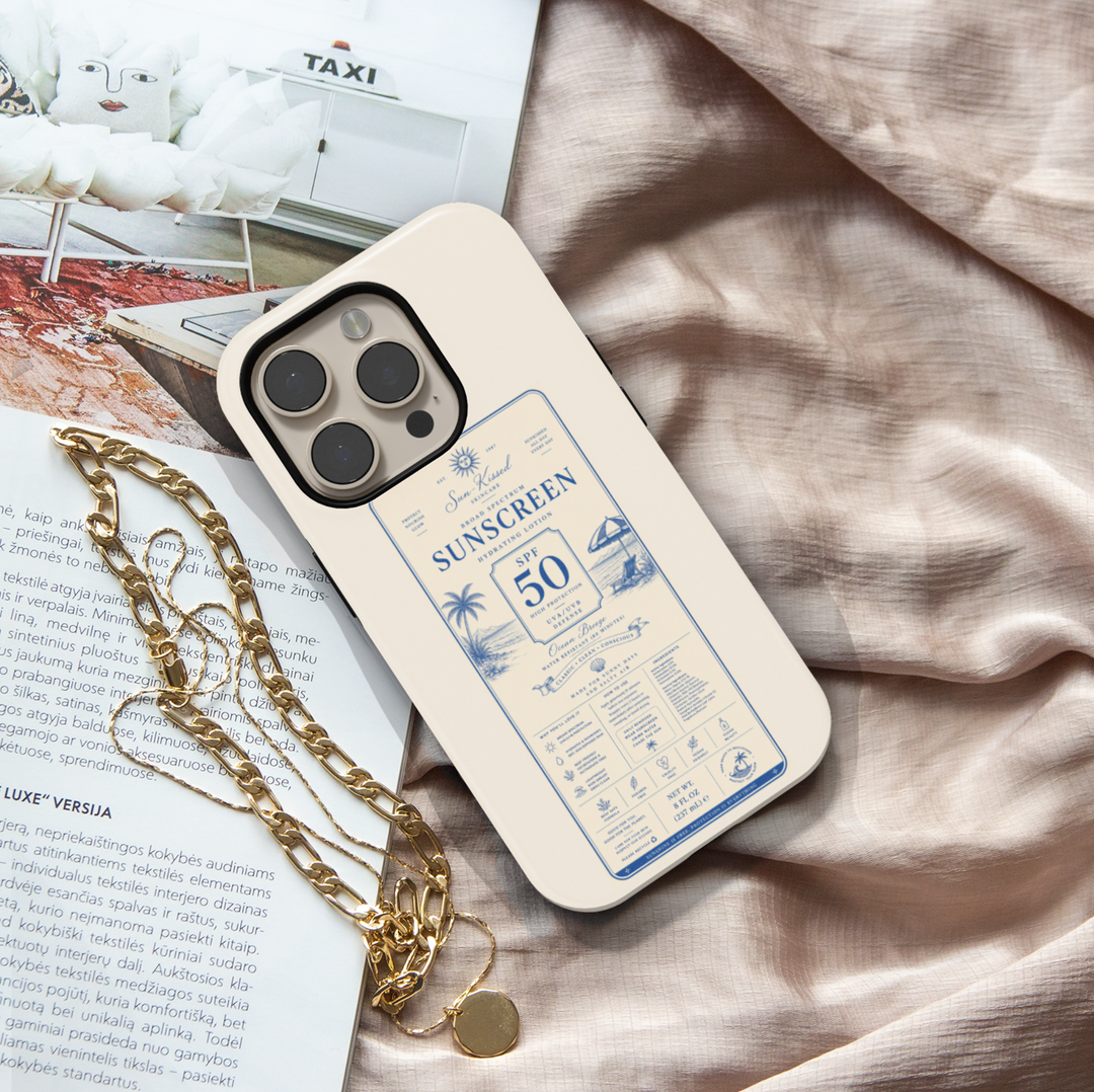 Vintage sunscreen label iPhone case featuring SPF 50 beach-inspired artwork with coastal scenery, palm trees, and retro summer aesthetics.