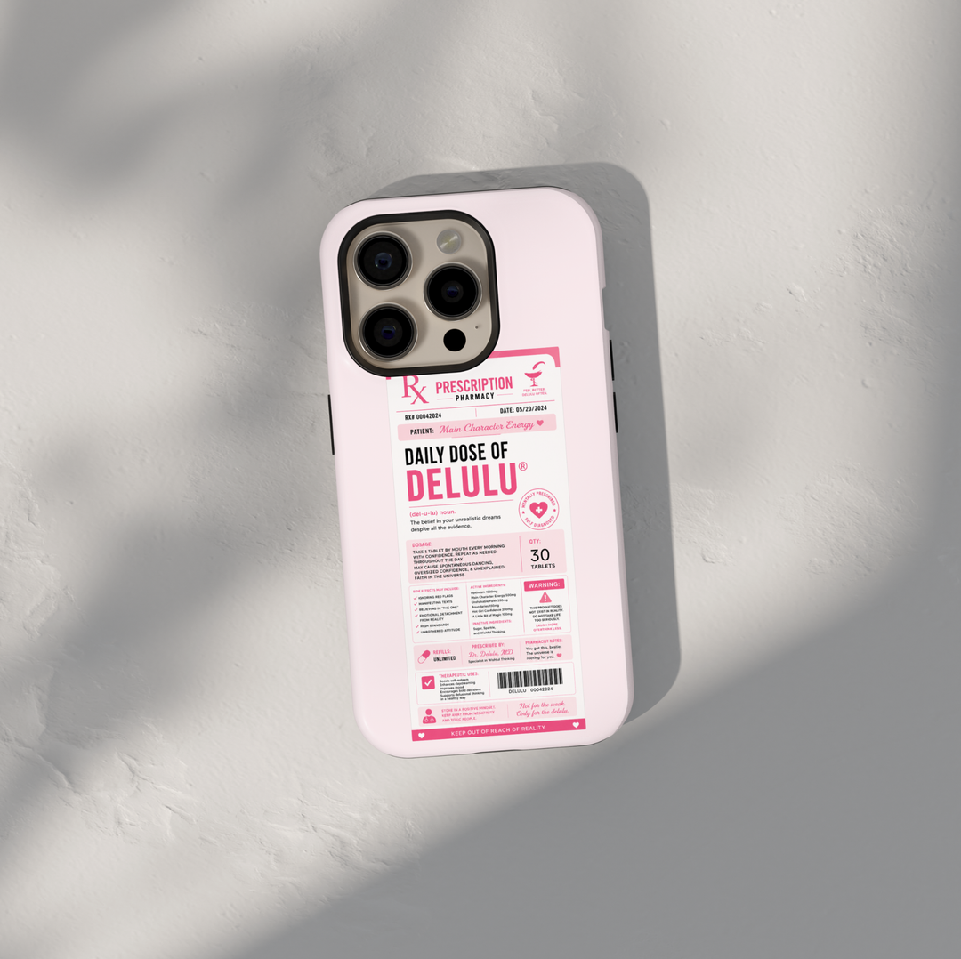 Funny pink iPhone case featuring a Daily Dose of Delulu prescription label with main character energy and humorous pharmacy-themed artwork.