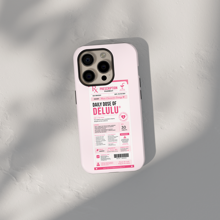 Funny pink iPhone case featuring a Daily Dose of Delulu prescription label with main character energy and humorous pharmacy-themed artwork.