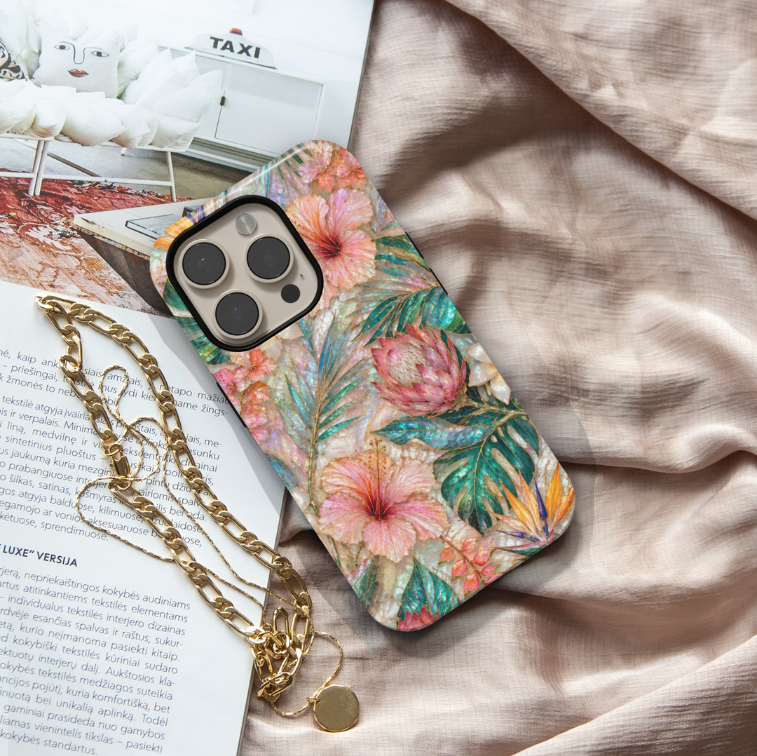 Tropical floral iPhone 17 Pro Max case featuring hibiscus flowers, protea blooms, bird of paradise, and teal botanical leaves.