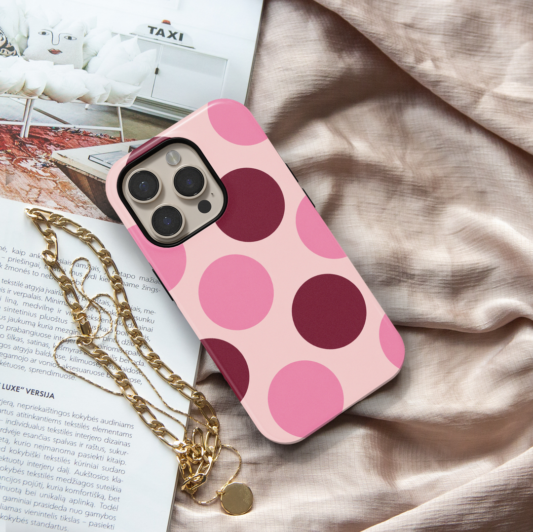 Double Take pink polka dot iPhone 18 Pro Max MagSafe case featuring oversized blush pink, rosy pink and deep burgundy circles on a pale pink background, a retro preppy tough iPhone 18 Pro phone case with feminine girly aesthetic, bold circle pattern, protective design and MagSafe compatibility.