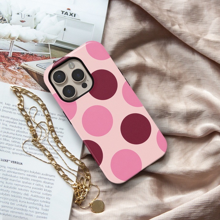 Double Take pink polka dot iPhone 18 Pro Max MagSafe case featuring oversized blush pink, rosy pink and deep burgundy circles on a pale pink background, a retro preppy tough iPhone 18 Pro phone case with feminine girly aesthetic, bold circle pattern, protective design and MagSafe compatibility.