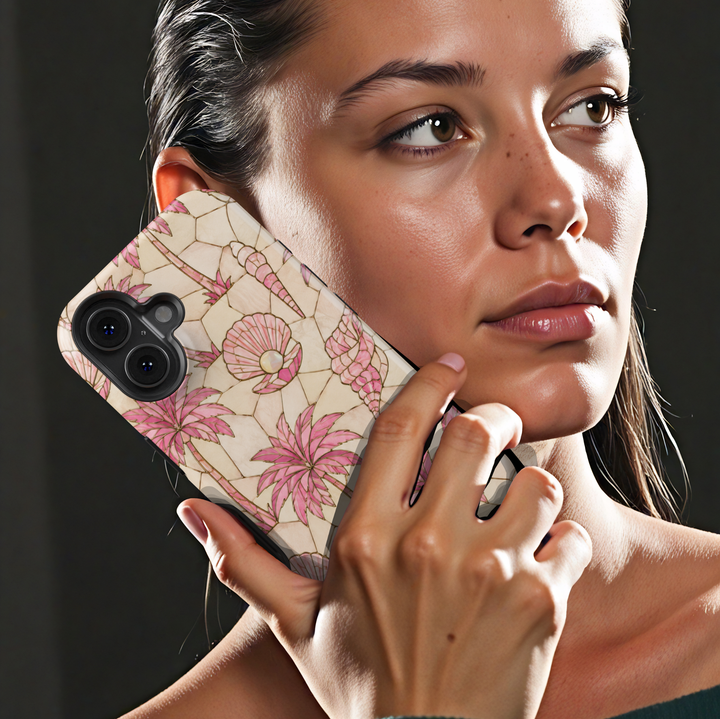 Pink tropical iPhone case featuring palm trees, seashells, pearls, and a soft coastal mosaic design.