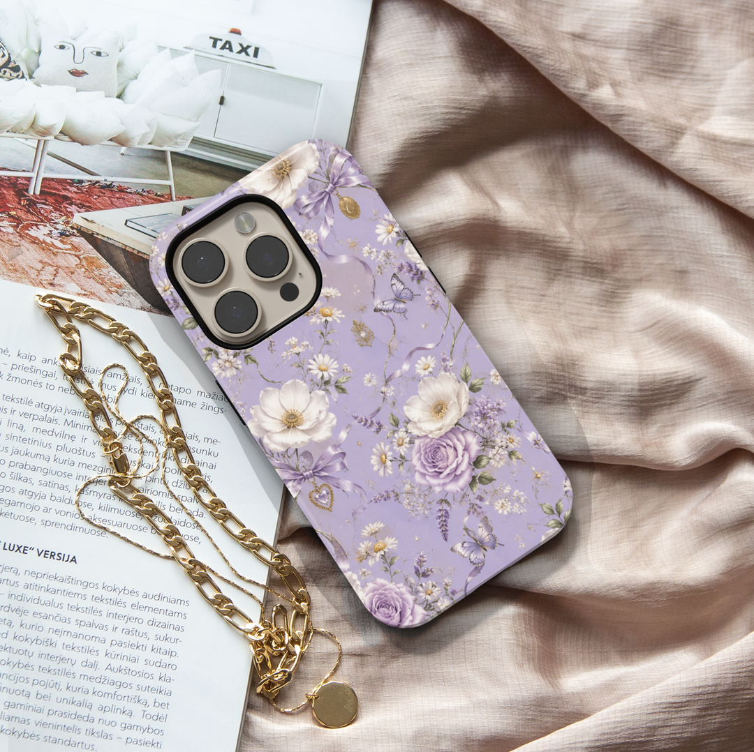 Lavender Reverie iPhone case with purple and ivory flowers, butterflies, lavender bows and vintage heart charms on a lilac background.