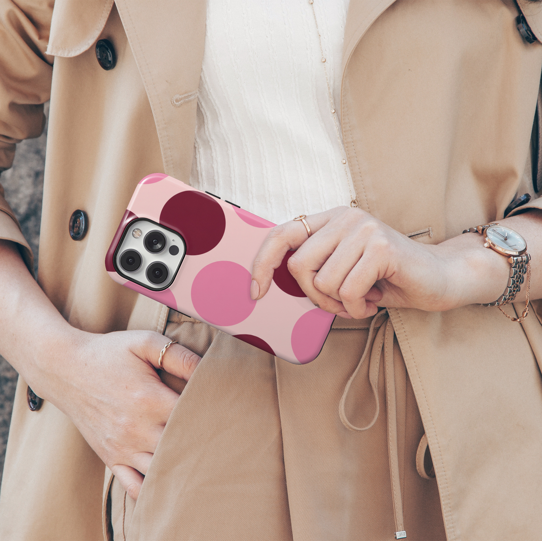 Double Take pink polka dot iPhone 18 Pro Max MagSafe case featuring oversized blush pink, rosy pink and deep burgundy circles on a pale pink background, a retro preppy tough iPhone 18 Pro phone case with feminine girly aesthetic, bold circle pattern, protective design and MagSafe compatibility.