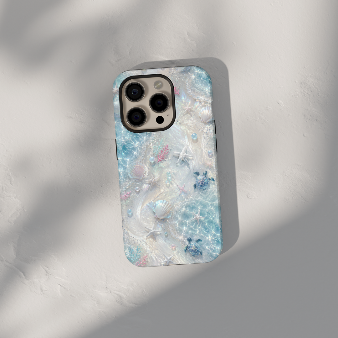Sea turtle iPhone case featuring seashells, starfish, coral accents, and shimmering ocean waves in soft aqua tones.