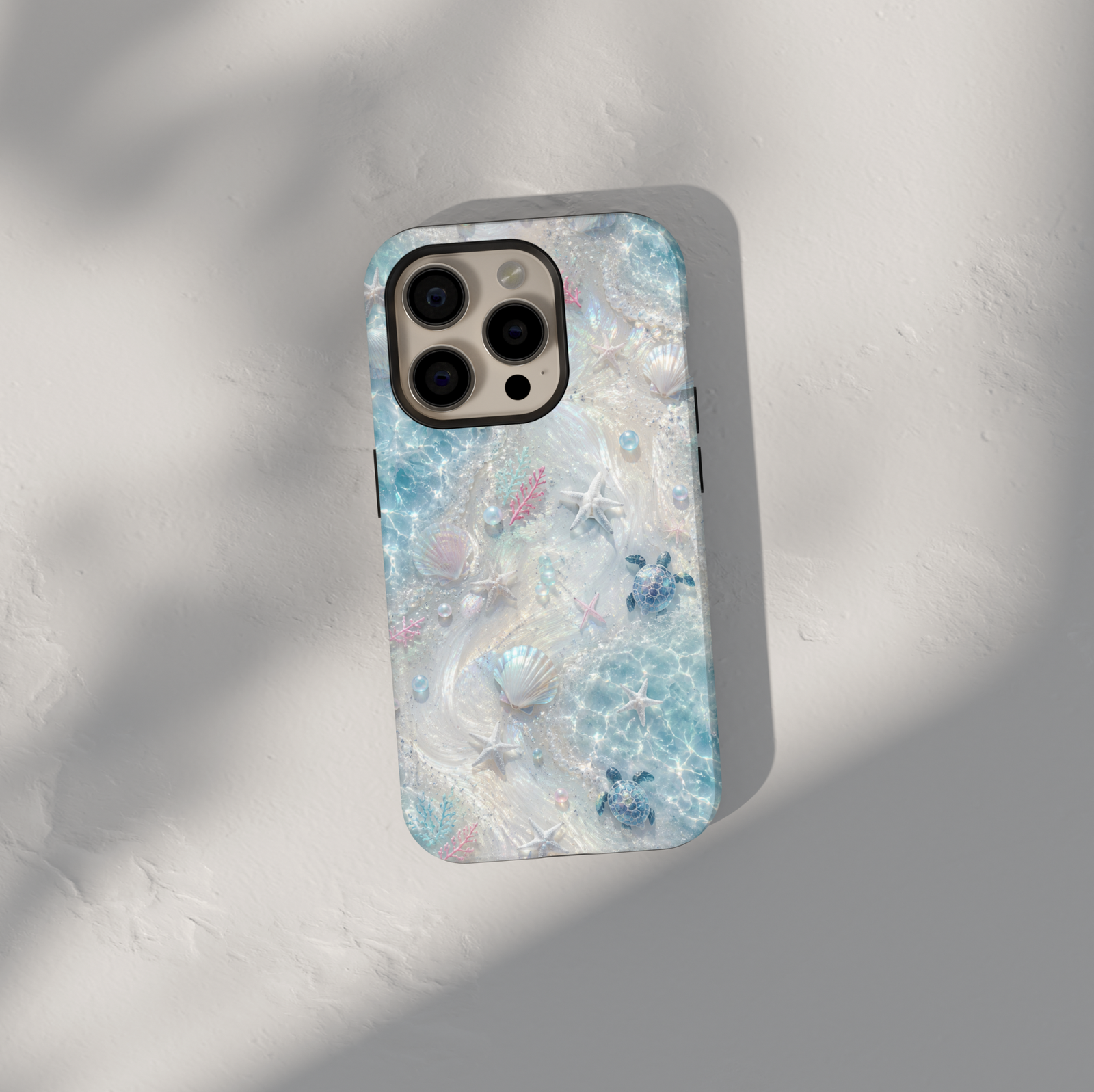 Sea turtle iPhone case featuring seashells, starfish, coral accents, and shimmering ocean waves in soft aqua tones.