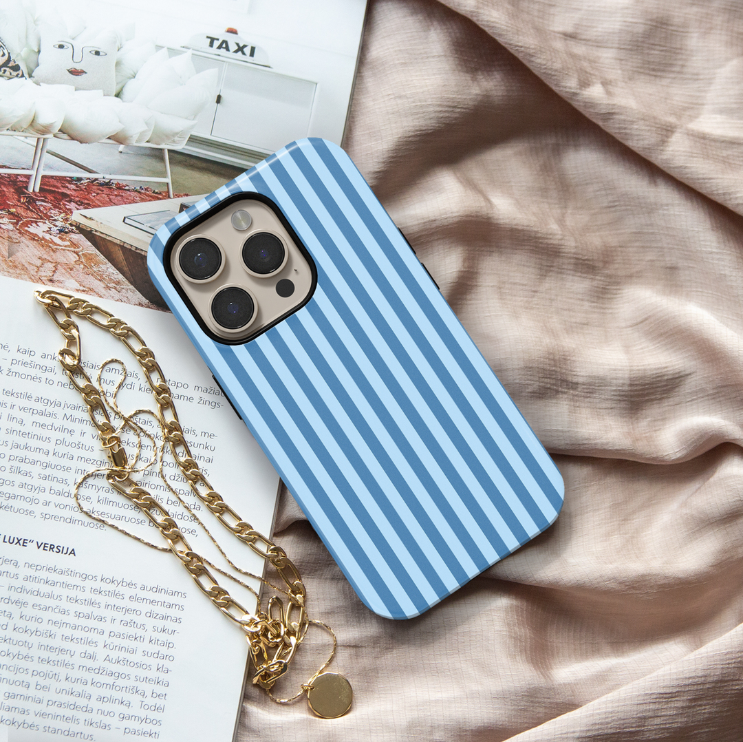Blue Routine blue striped iPhone 18 Pro Max MagSafe case featuring vertical powder blue and denim blue stripes, a clean preppy minimalist tough iPhone 18 Pro phone case with light blue aesthetic, classic striped design, protective style and MagSafe compatibility.