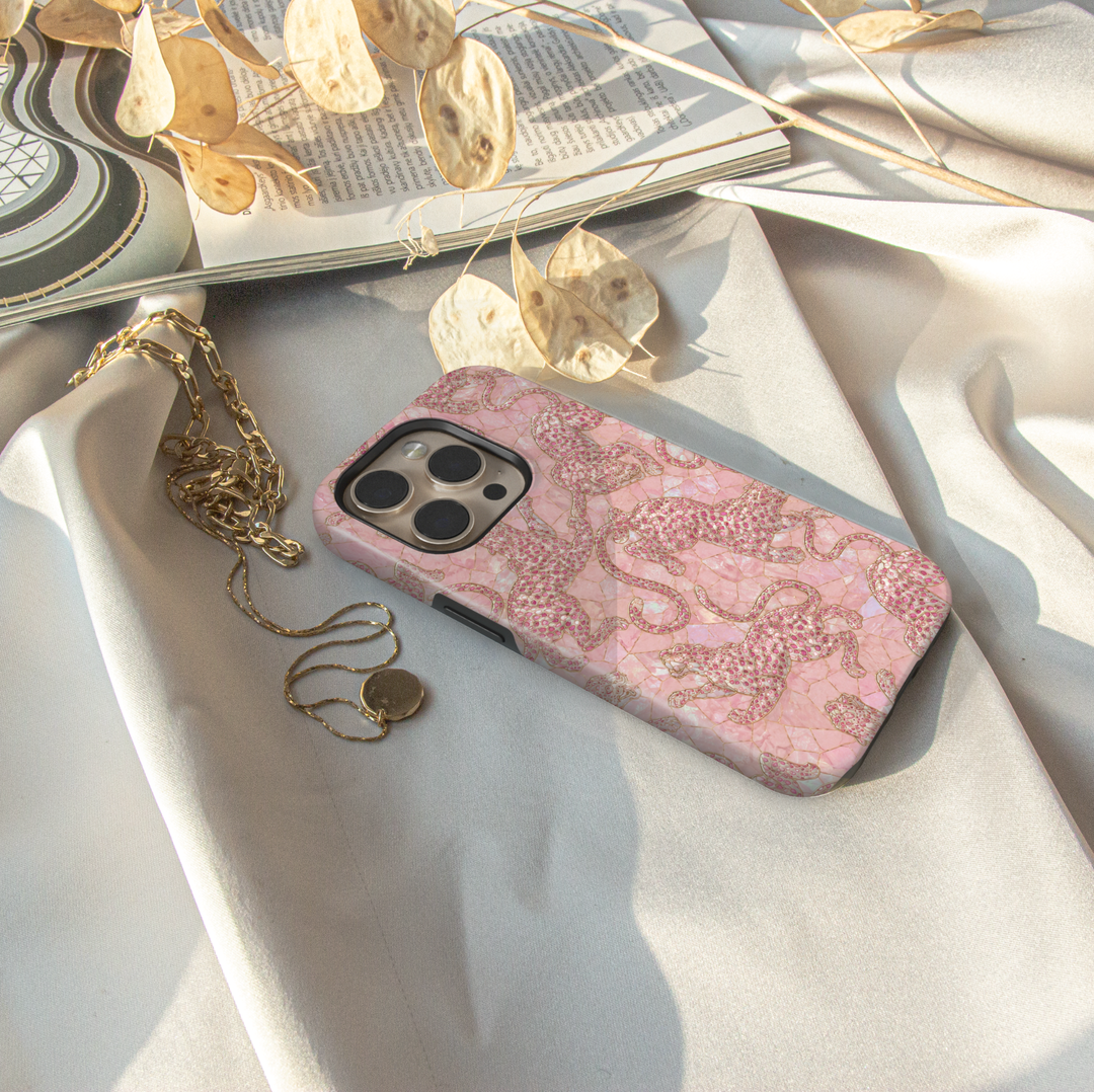 Blush Prowl iPhone case featuring pink leopards on a soft blush pearl-inspired mosaic background with delicate gold details.