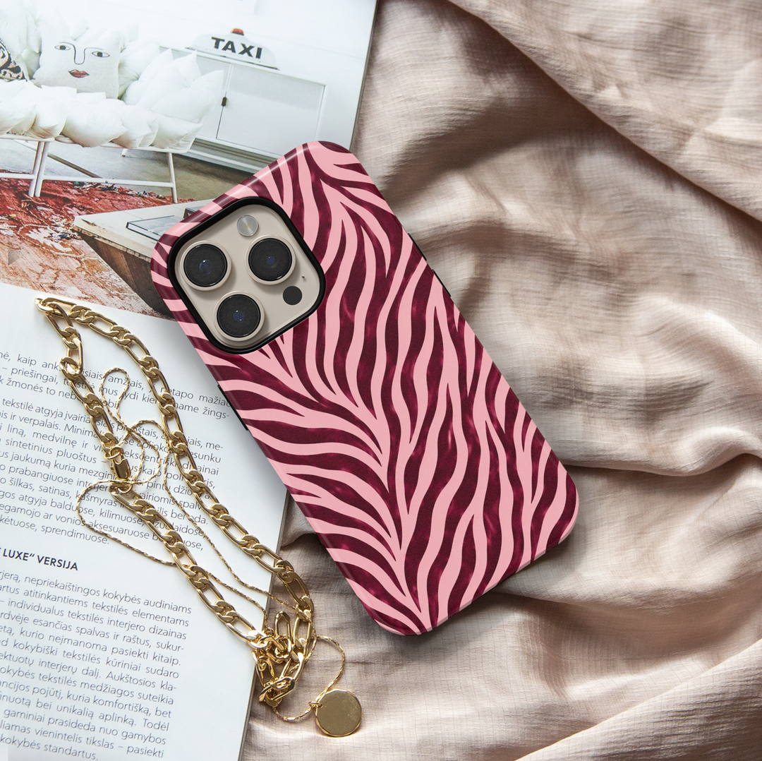 Wild Intentions burgundy zebra iPhone 18 Pro Max MagSafe case featuring deep burgundy, dark cherry, wine red and blush pink zebra stripes, a bold feminine protective tough iPhone 18 Pro phone case with a trendy animal print design and MagSafe compatibility.