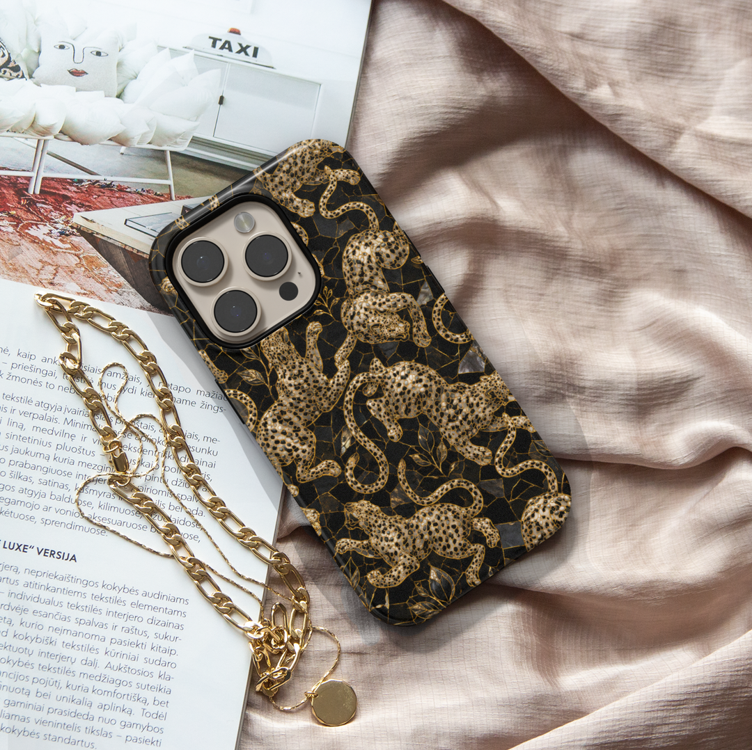Golden Prowl iPhone case with ornate gold leopards, botanical details and a luxurious black background.