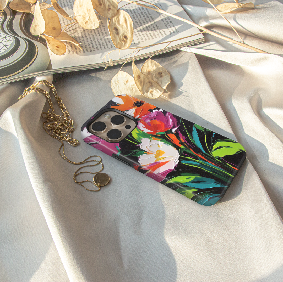Modern abstract floral iPhone case featuring vibrant colorful flowers with white blossoms on a dark artistic background.