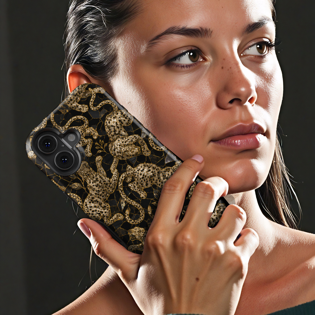 Golden Prowl iPhone case with ornate gold leopards, botanical details and a luxurious black background.