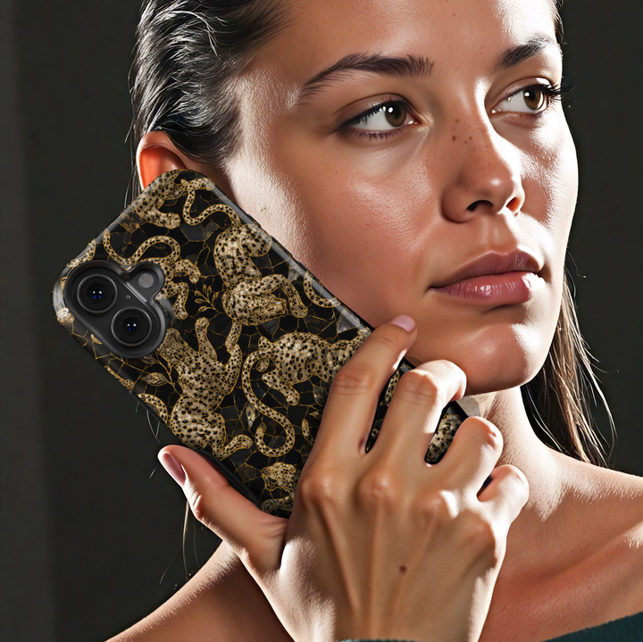 Golden Prowl iPhone case with ornate gold leopards, botanical details and a luxurious black background.