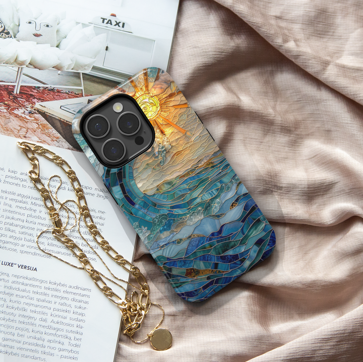 Ocean inspired stained glass art phone case with layered blue waves and golden sun on a protective iPhone and Samsung Galaxy phone case for women