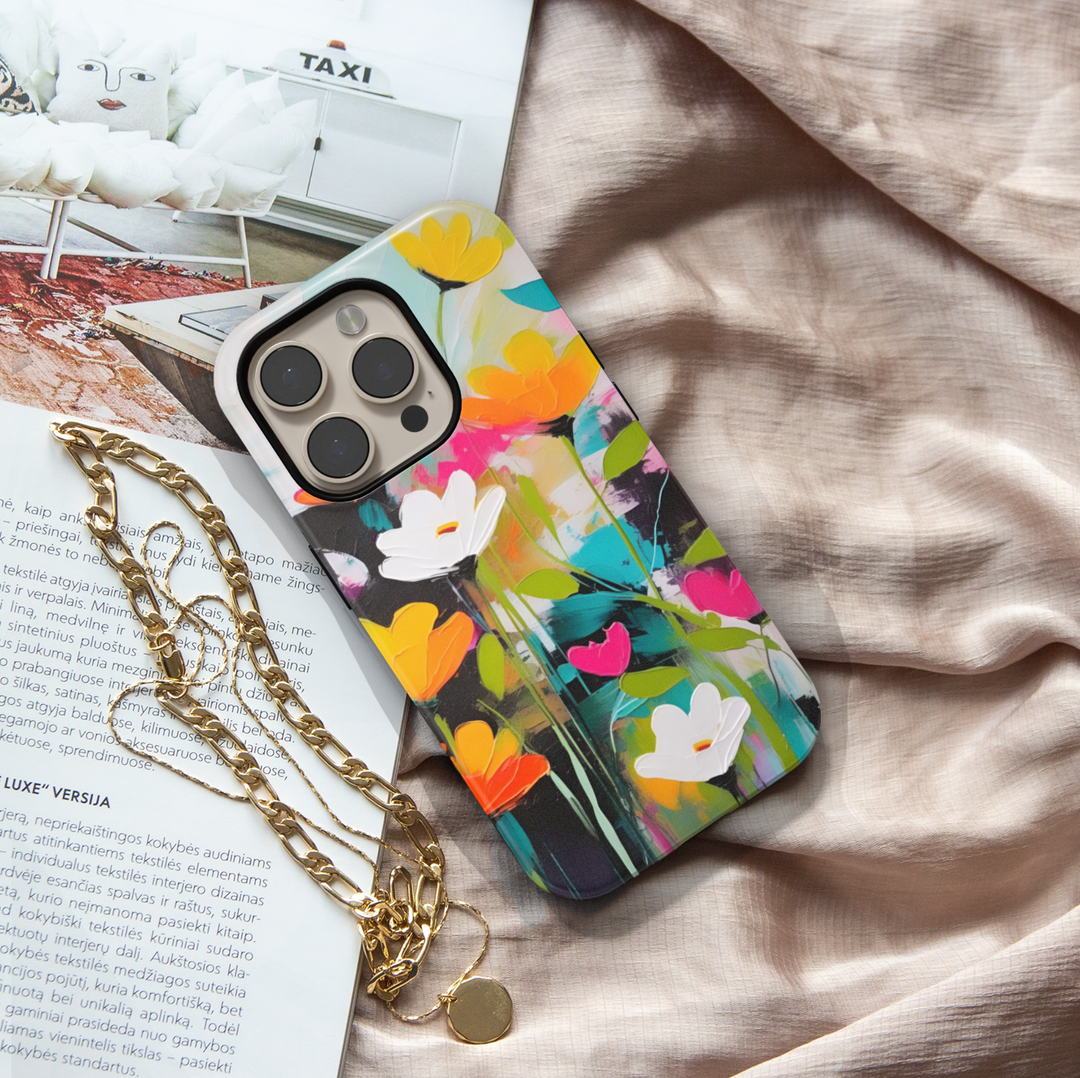 Modern abstract floral iPhone case featuring vibrant colorful flowers with white blossoms on a dark artistic background.