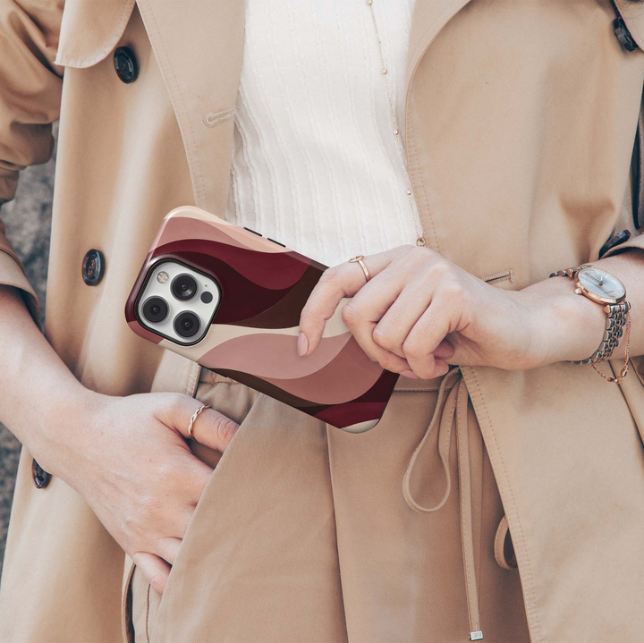 Cabernet Curve iPhone 18 Pro Max MagSafe case featuring flowing abstract waves in cabernet, burgundy, chocolate brown, dusty rose, blush and warm cream, a modern luxury tough iPhone 18 Pro phone case with MagSafe compatibility.
