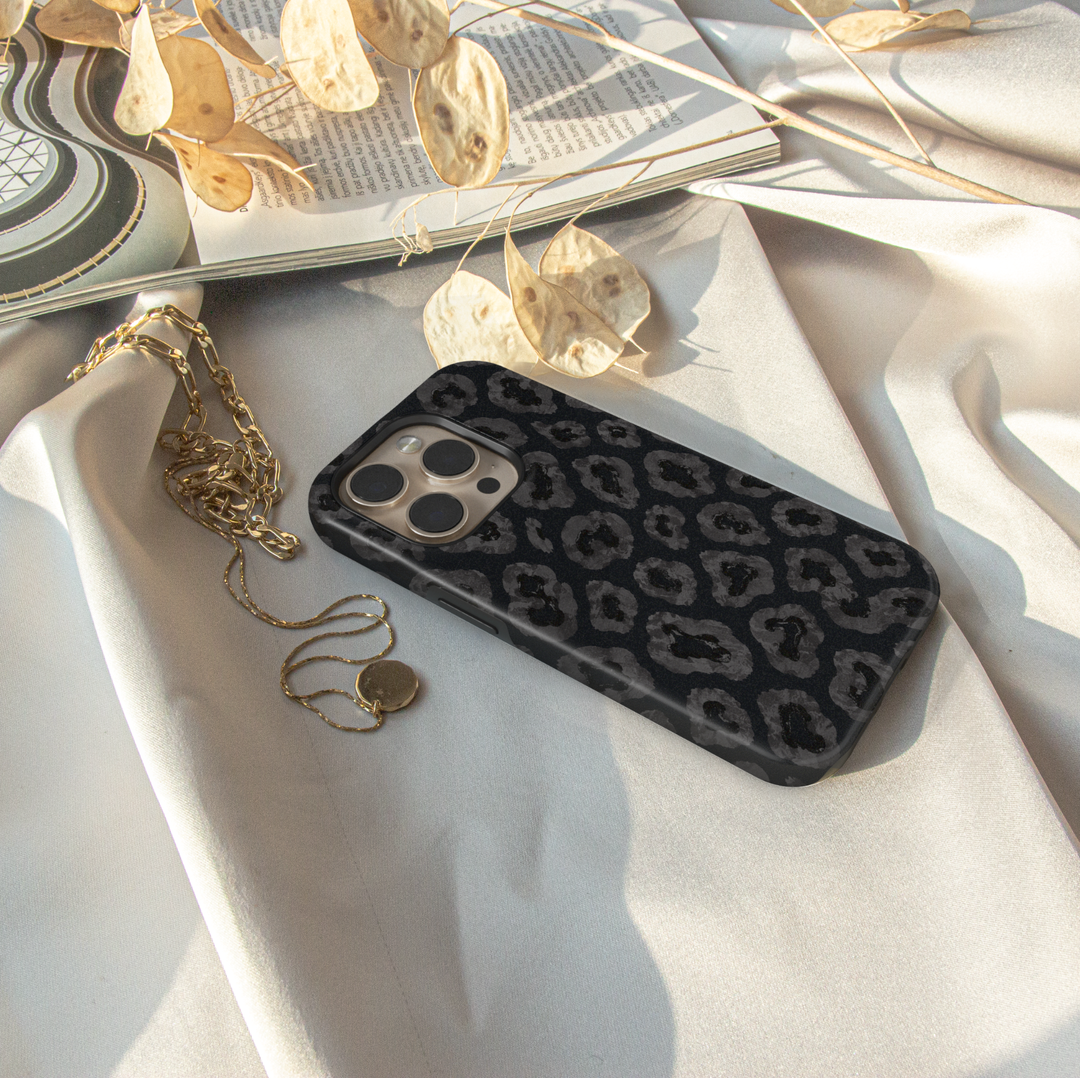 Black iPhone case leopards, botanical details and a luxurious black background.