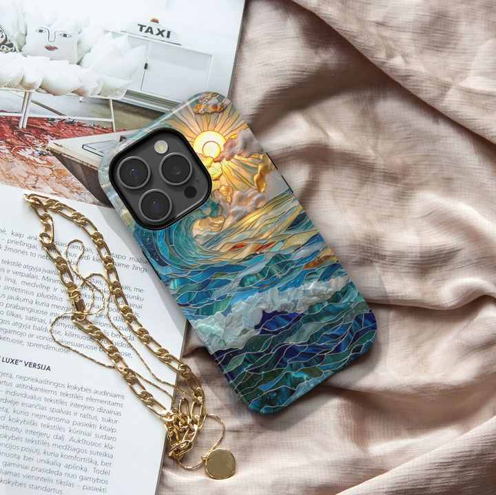 Ocean inspired stained glass art phone case with layered blue waves and golden sun on a protective iPhone and Samsung Galaxy phone case for women