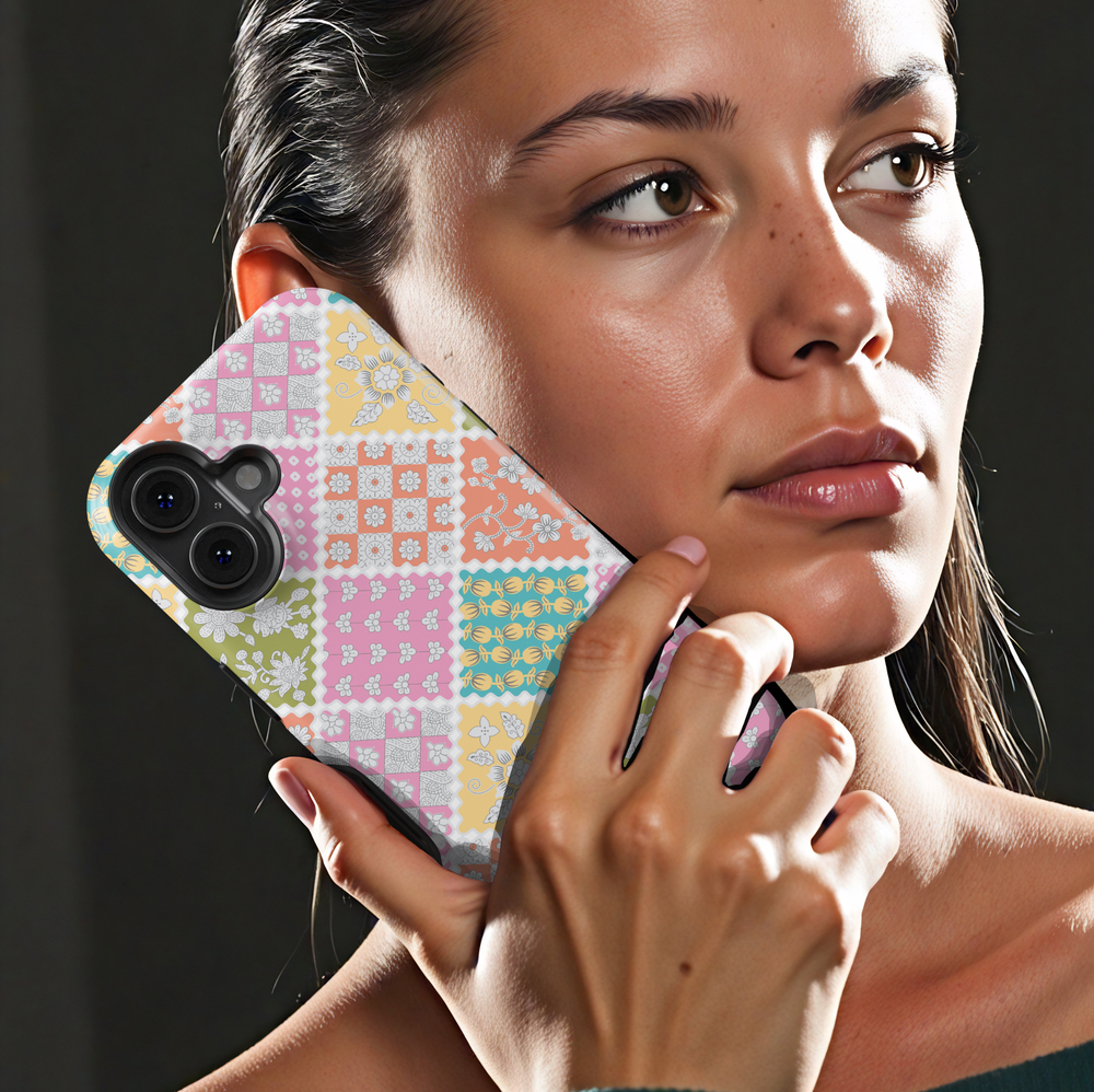 Pastel patchwork iPhone tough case with vintage floral tiles in pink, peach, green, and yellow