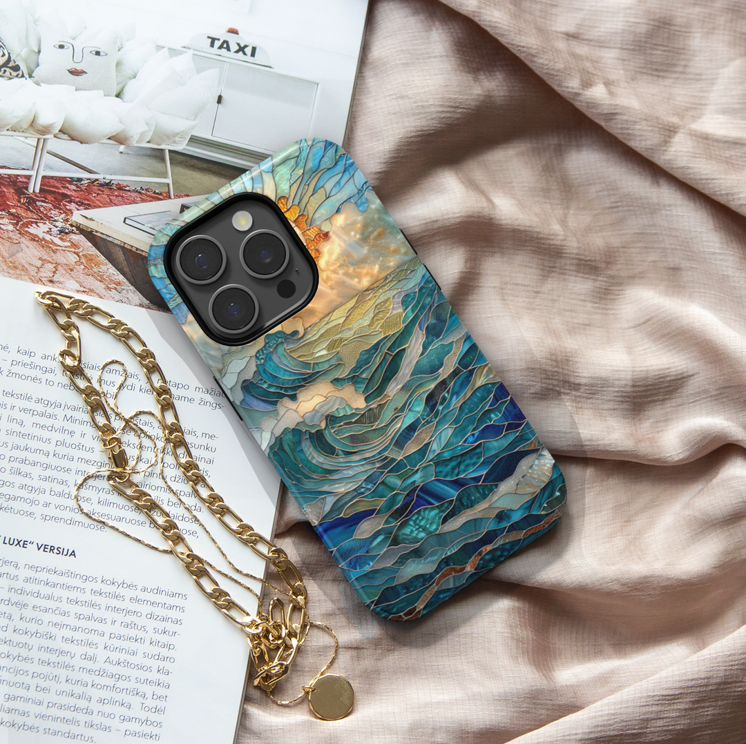 Ocean inspired stained glass art phone case with layered blue waves and golden sun on a protective iPhone and Samsung Galaxy phone case for women