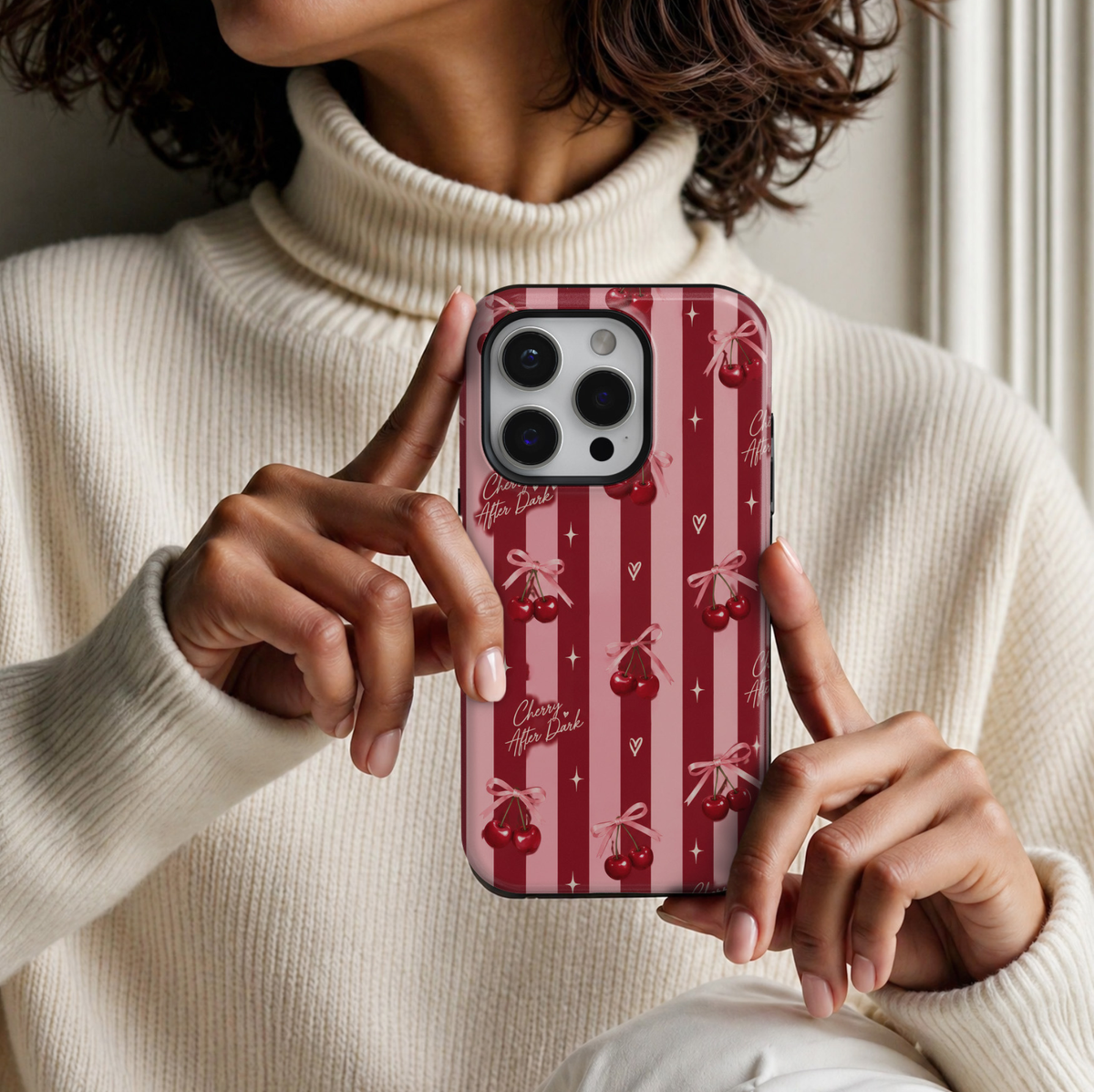 CASELIX Cherry After Dark iPhone 18 Pro Max tough phone case featuring deep burgundy red and pastel pink vertical stripes, glossy ruby-red cherry pairs with pink satin ribbon bows, delicate cream hearts, sparkling stars, and handwritten Cherry After Dark lettering. Cute feminine cherry print phone case for women with a glossy finish and romantic coquette aesthetic.