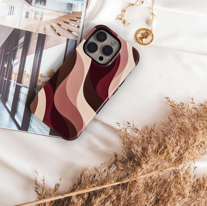 Cabernet Curve iPhone 18 Pro Max MagSafe case featuring flowing abstract waves in cabernet, burgundy, chocolate brown, dusty rose, blush and warm cream, a modern luxury tough iPhone 18 Pro phone case with MagSafe compatibility.