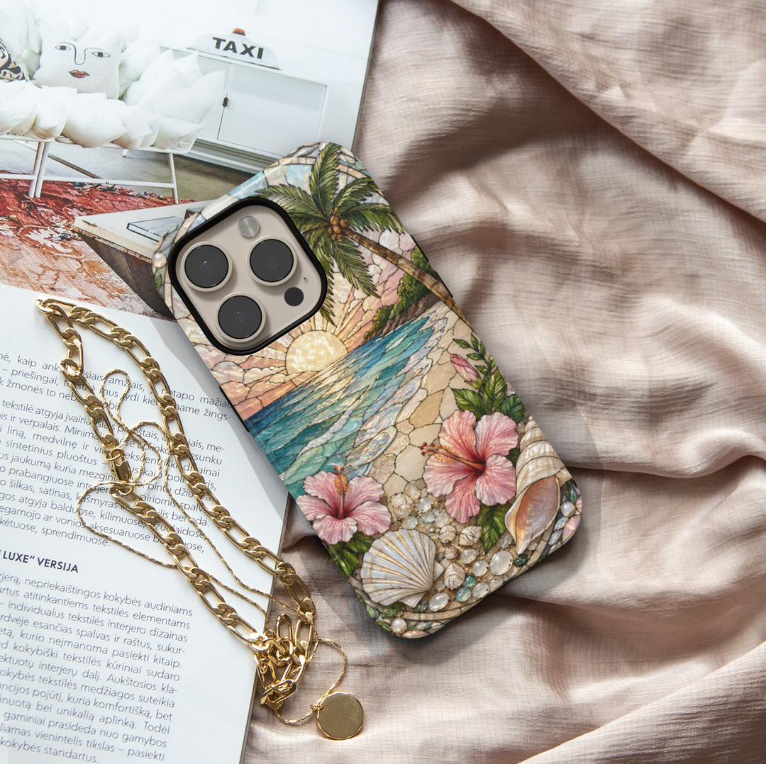 Tropical beach sunset iPhone 17 Pro Max case with hibiscus flowers, seashells, ocean waves, and pearl-inspired details.