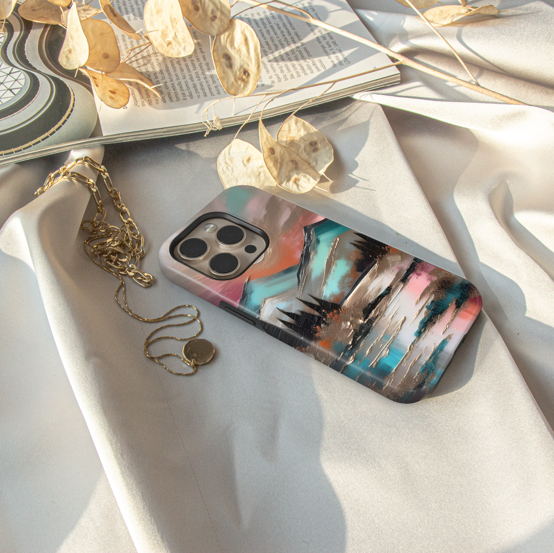 Modern landscape iPhone case featuring turquoise mountains, a reflective lake, and a colorful sunset sky.