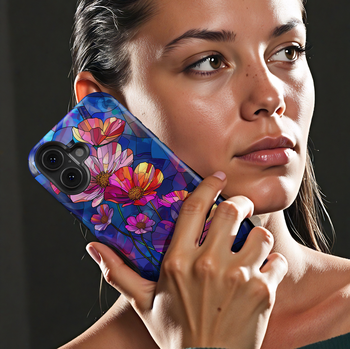 Stained glass style wildflower iPhone tough case with vibrant pink, purple, and orange flowers on deep blue background