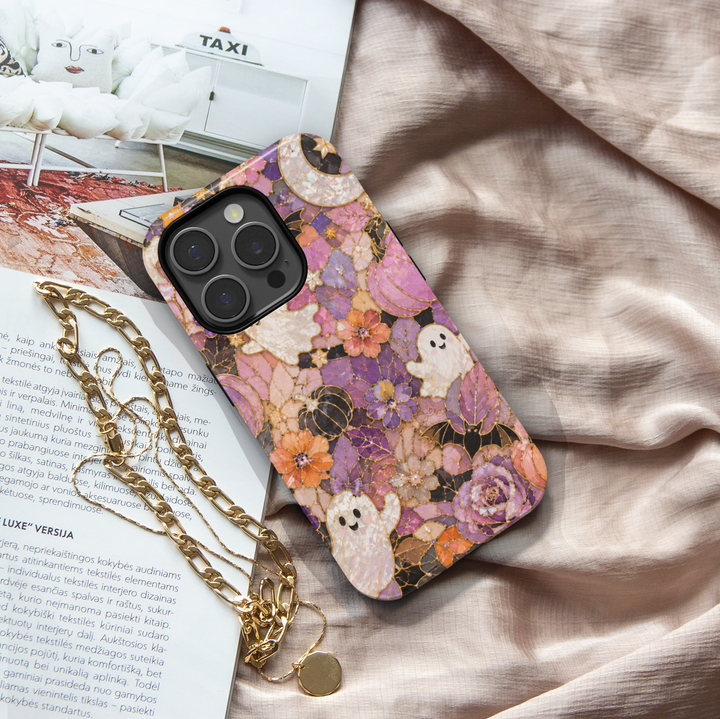 Floral Halloween iPhone case with pearl ghosts, bats, pumpkins, crescent moon and purple pink orange stained glass flowers.