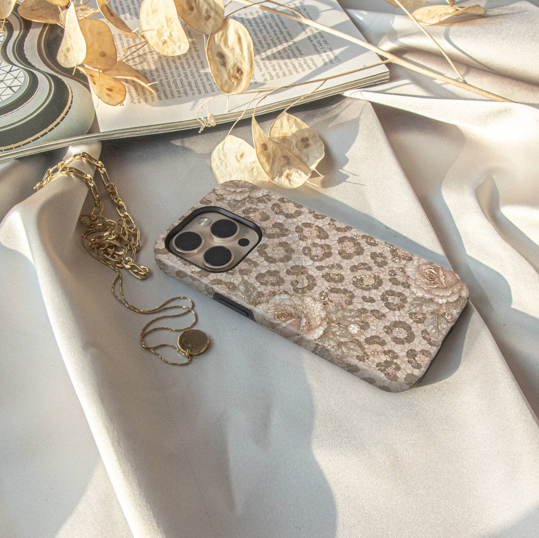 Luxury iPhone case featuring pearl snow leopard print, ivory roses, champagne gold accents, and elegant neutral mosaic artwork.