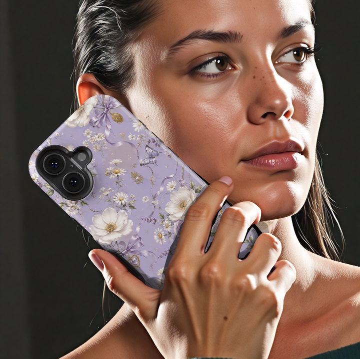 Lavender Reverie iPhone case with purple and ivory flowers, butterflies, lavender bows and vintage heart charms on a lilac background.