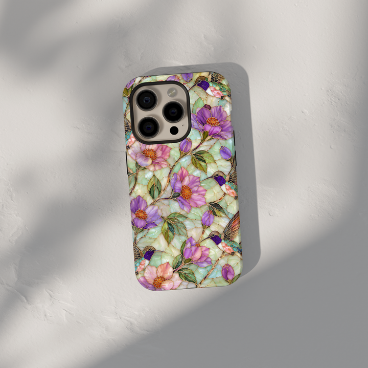 Elegant hummingbird iPhone case featuring lavender flowers, pastel blossoms, green leaves, and colorful hummingbirds with gold detailing.