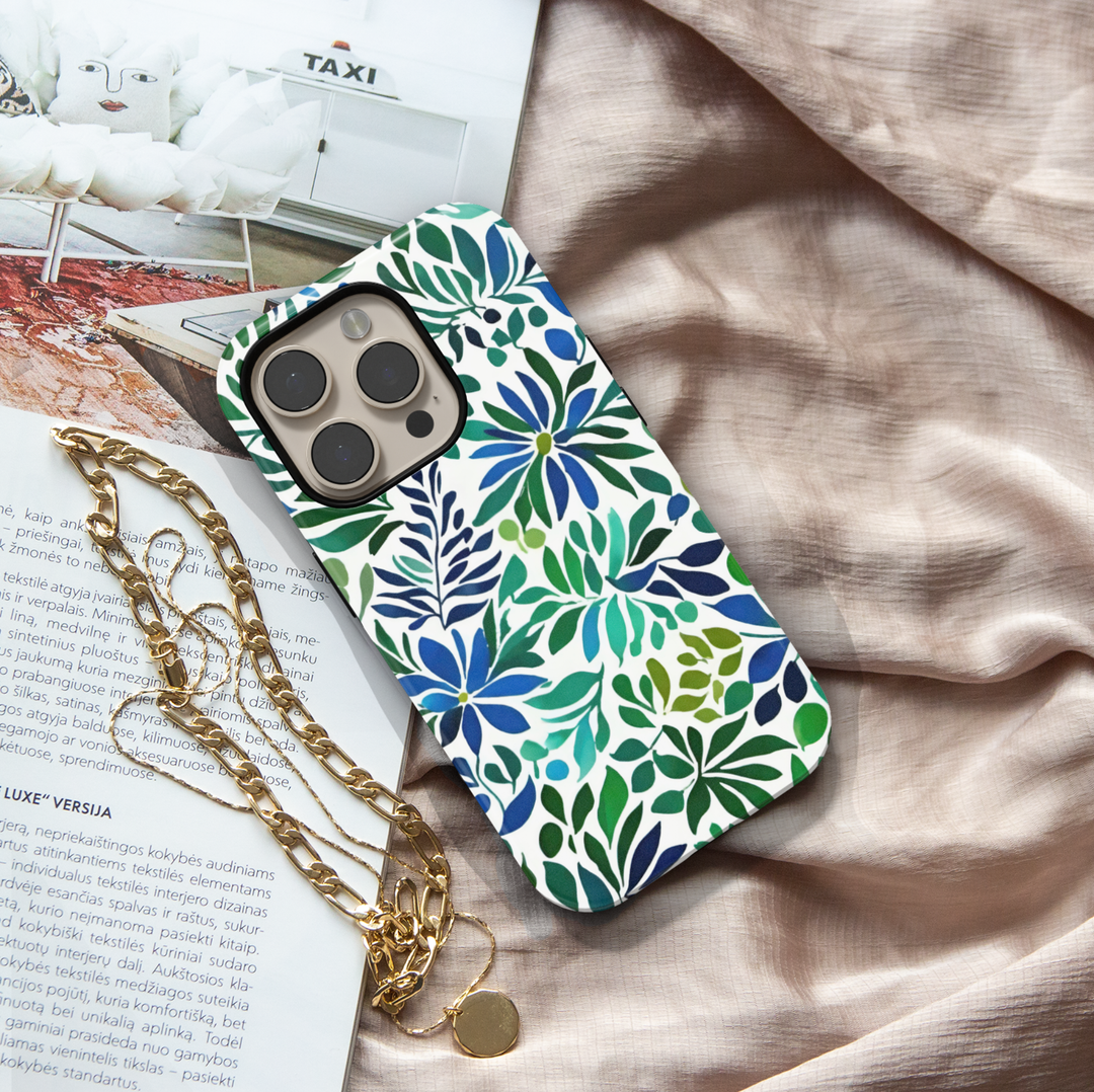 Blue and green botanical iPhone case featuring floral blooms and leafy watercolor-inspired artwork on a white background.