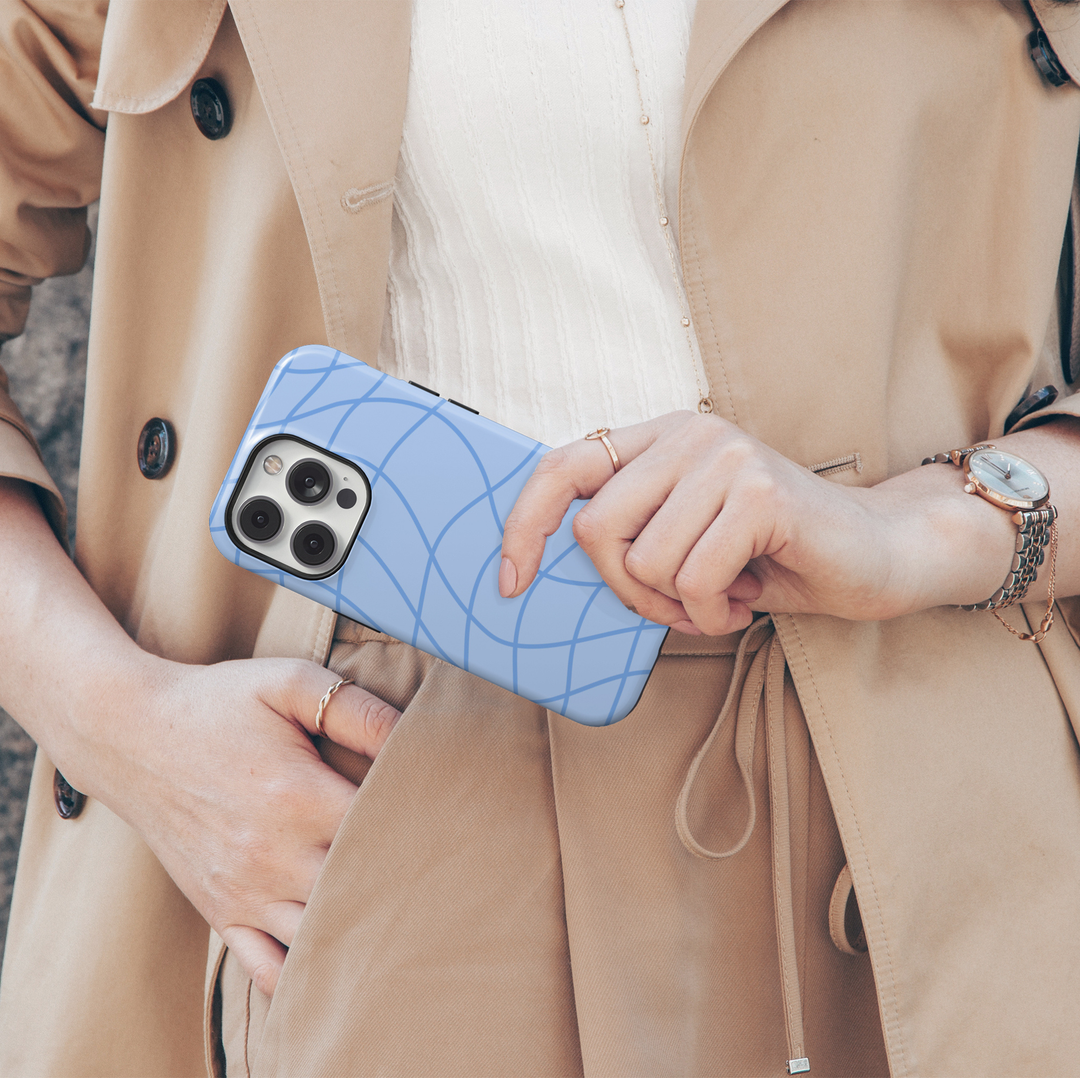 Out of Line abstract blue iPhone 18 Pro Max MagSafe case featuring curved cornflower blue line art over a soft powder blue background, a minimalist modern protective tough iPhone 18 Pro phone case with an aesthetic geometric line pattern and MagSafe compatibility.