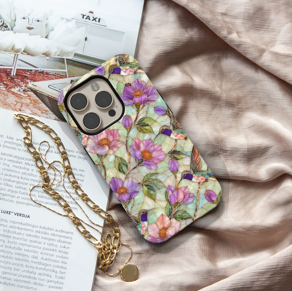 Elegant hummingbird iPhone case featuring lavender flowers, pastel blossoms, green leaves, and colorful hummingbirds with gold detailing.