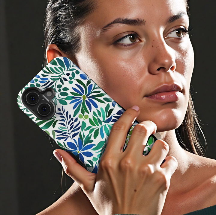 Blue and green botanical iPhone case featuring floral blooms and leafy watercolor-inspired artwork on a white background.