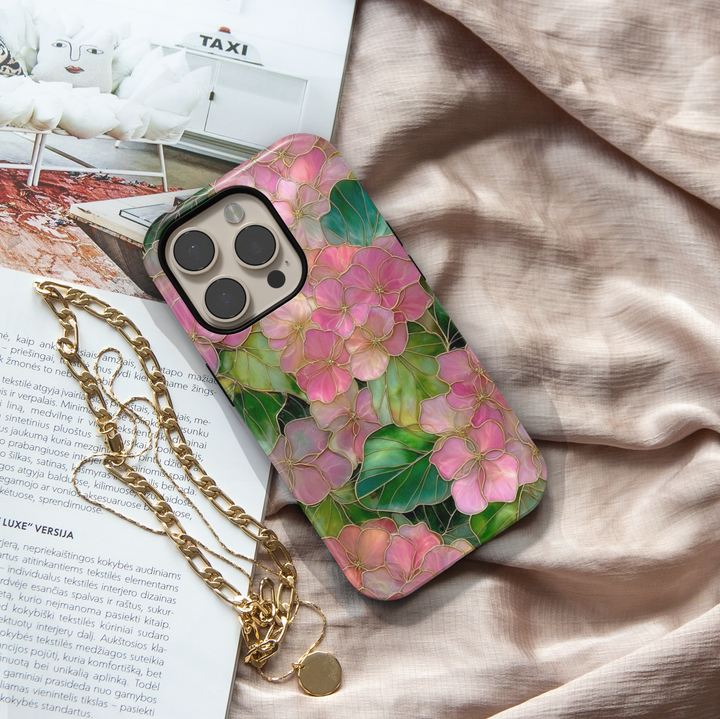 Pink floral iPhone 17 Pro Max case with gold outlined flowers and green leaves, aesthetic MagSafe tough case.