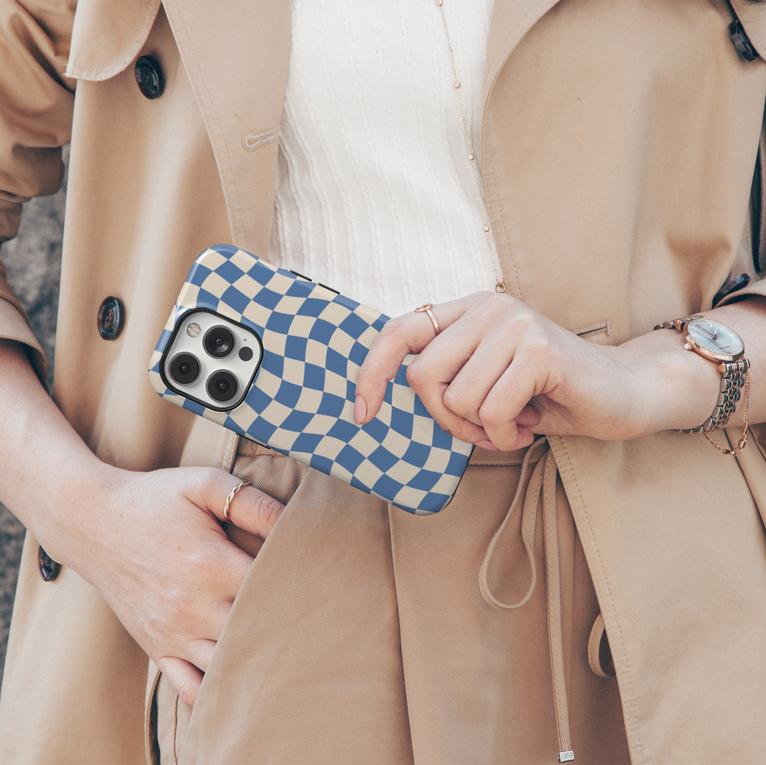 Making Waves blue checkerboard iPhone 18 Pro Max MagSafe case featuring a wavy blue and warm cream checkered pattern, a retro preppy protective tough iPhone 18 Pro phone case with an aesthetic distorted checkerboard design and MagSafe compatibility.