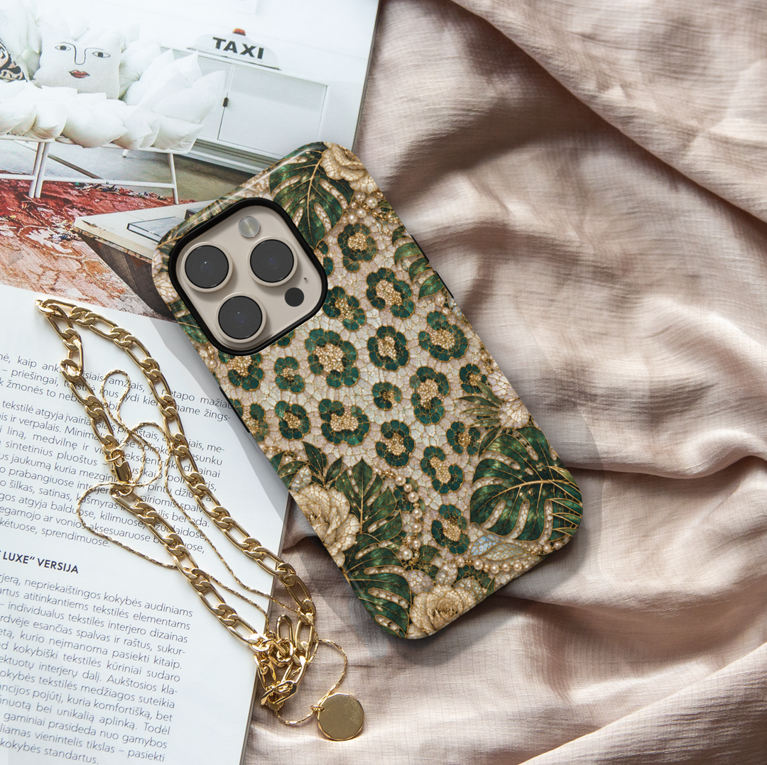 Luxury iPhone case featuring emerald green leopard print, tropical monstera leaves, ivory roses, pearls, and gold mosaic artwork.