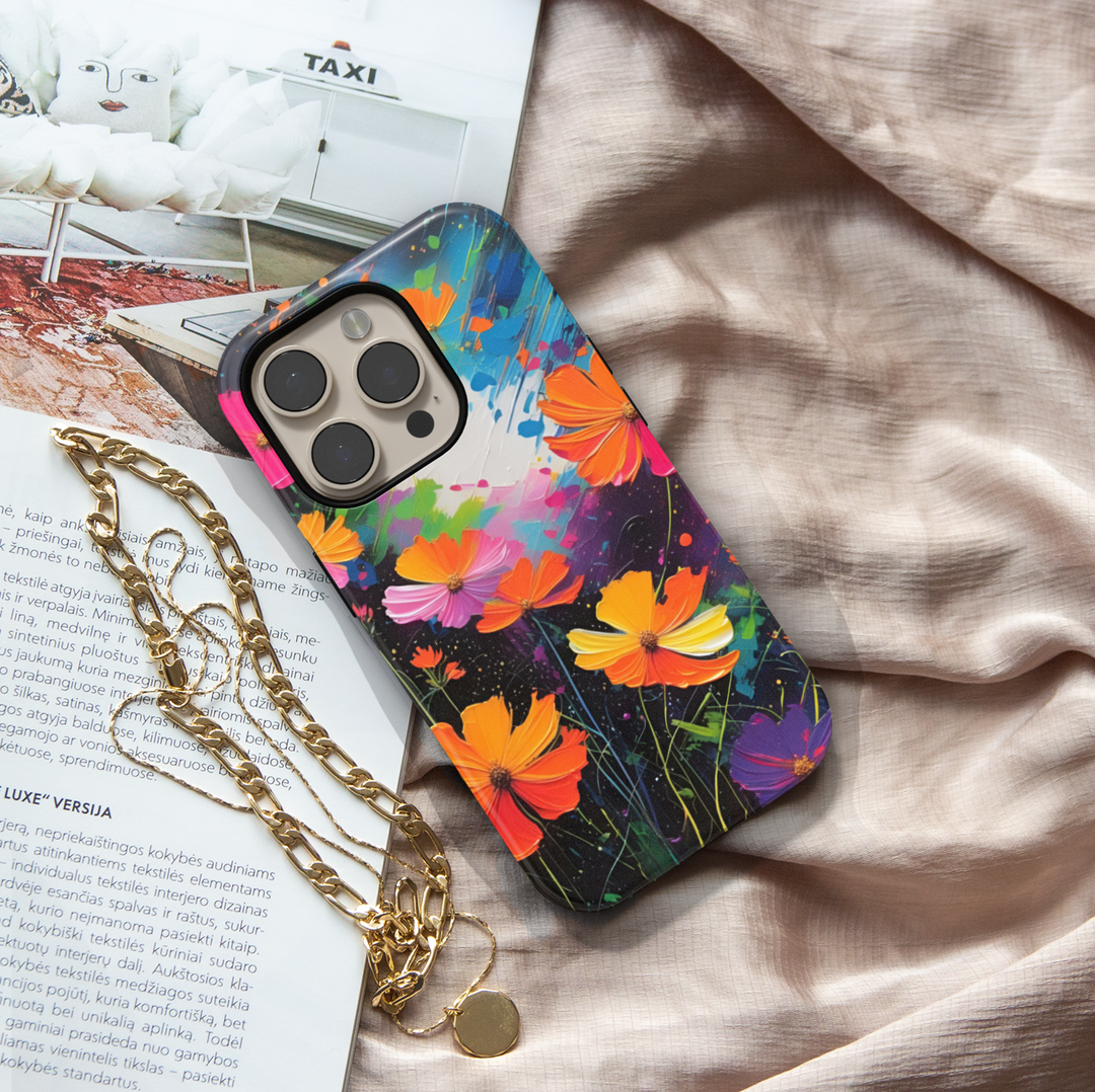 Abstract wildflower iPhone case featuring vibrant orange, pink, yellow, and purple flowers on a colorful artistic background.
