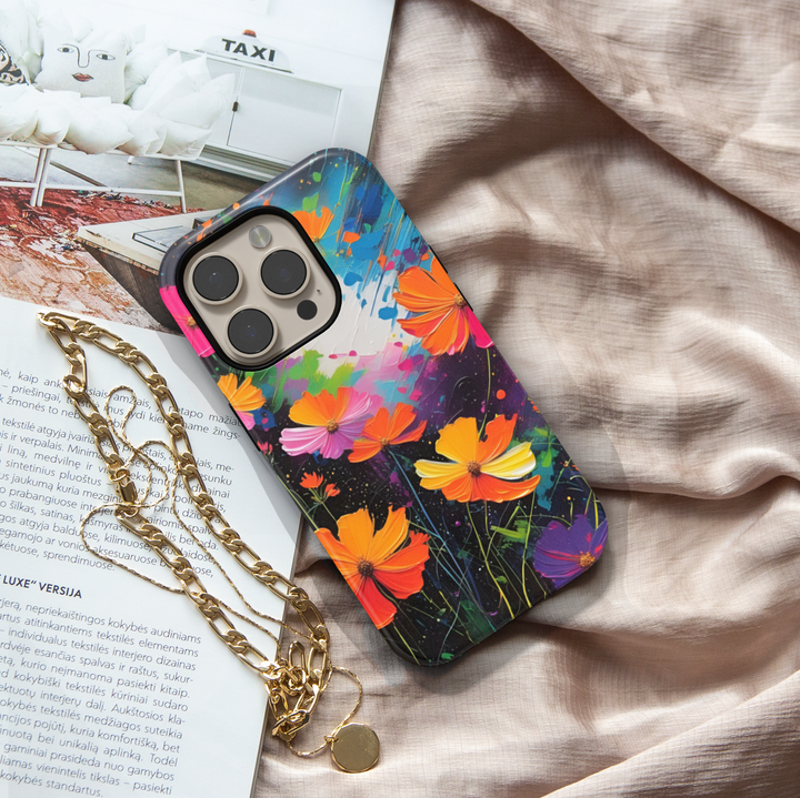 Abstract wildflower iPhone case featuring vibrant orange, pink, yellow, and purple flowers on a colorful artistic background.